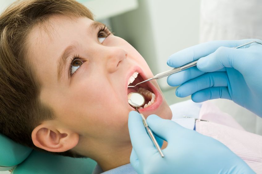 4843248 – close-up of little boy opening his mouth during dental checkup